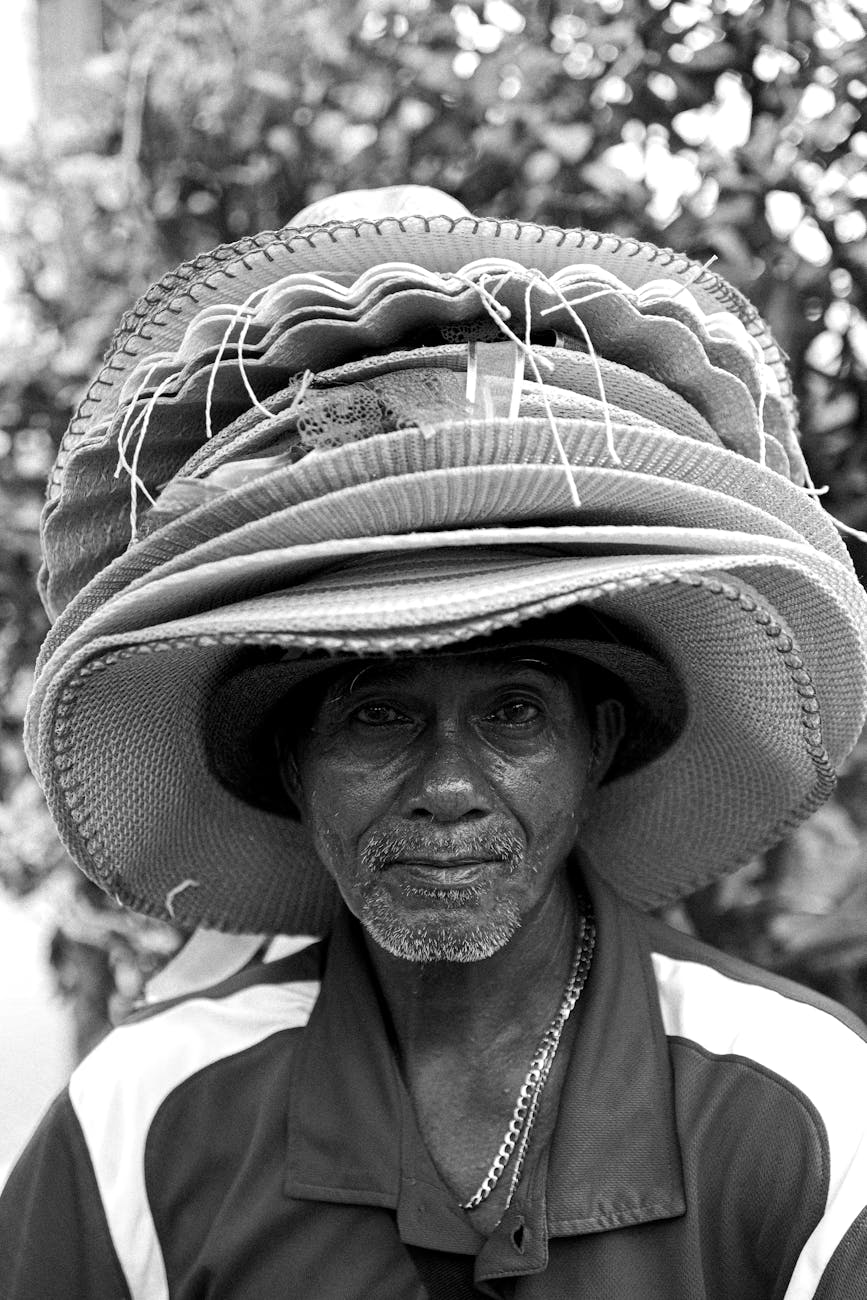 portrait of man with stack of hats