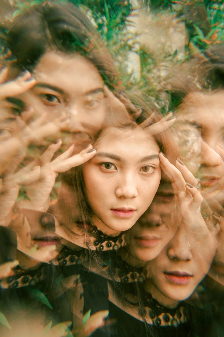 portrait of a woman with her hands on her head