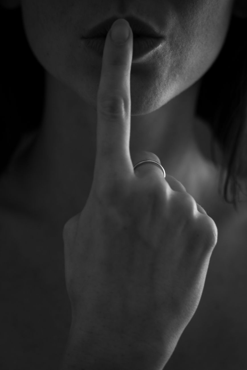 grayscale photo of woman touching her lips